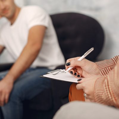 In the psychologist's office. Man and woman talking